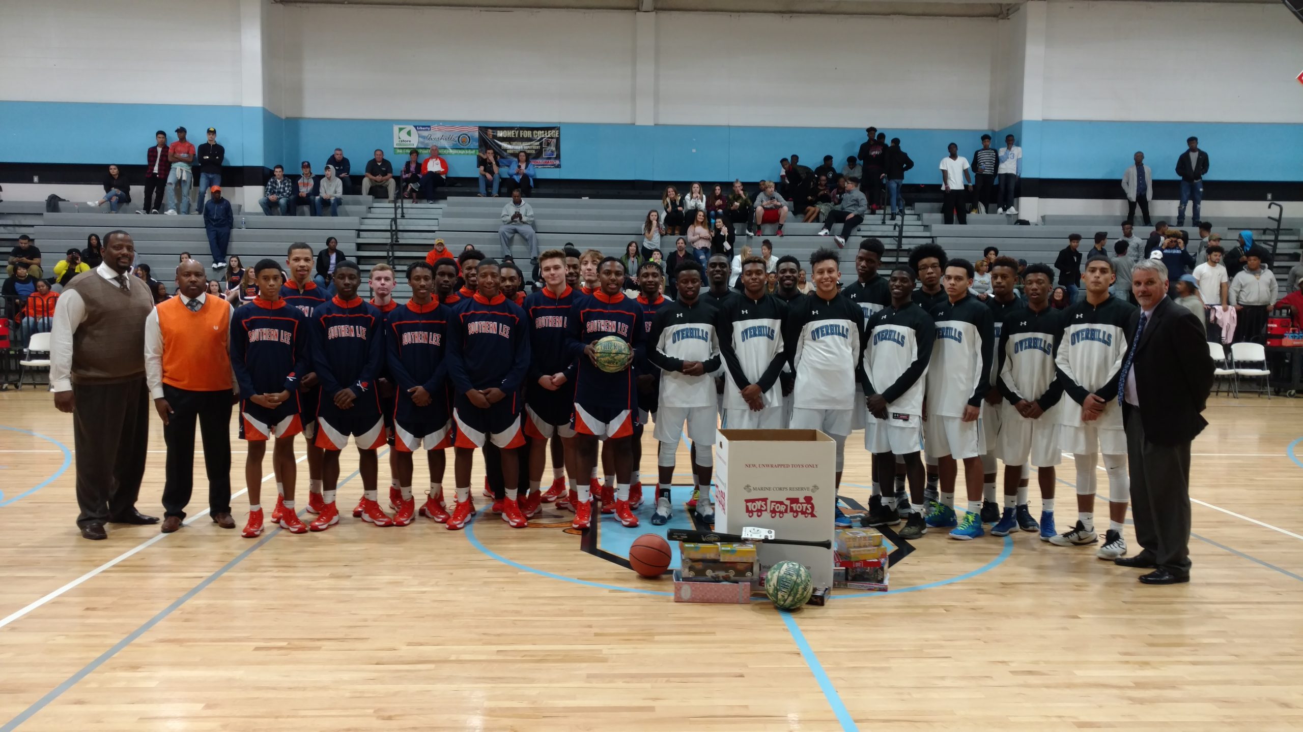 Southern Lee and Overhills basketball players pose with their donations to Toys for Tots campaign prior to their game.